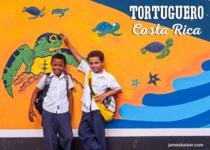 Children in front of a sea turtle mural in Tortuguero, Costa Rica